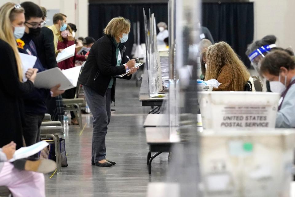 Recount observers watch ballots during a Milwaukee hand recount in November 2020 (AP)