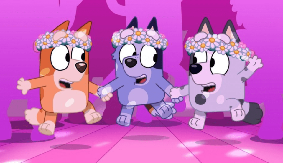 Animated character Bluey wish his sister Bingo and a friend wearing flower headbands
