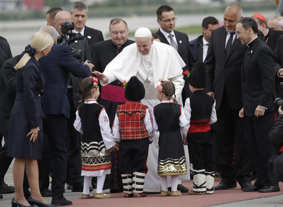 Pope Francis is welcomed by children wearing traditional dresses upon his arrival in Sofia, Bulgaria, Sunday, May 5, 2019. Pope Francis is visiting Bulgaria, the European Union's poorest country and one that taken a hard line against migrants, a stance that conflicts with the pontiff's view that reaching out to vulnerable people is a moral imperative. (AP Photo/Alessandra Tarantino)