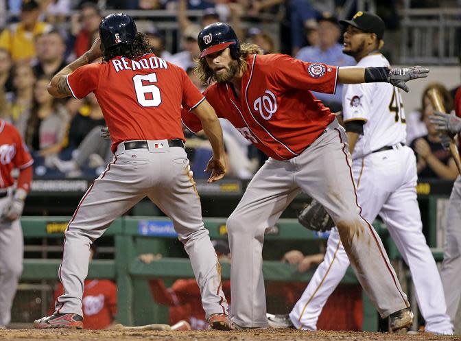 Anthony Rendon celebrates with Jayson Werth after they both scored on a bases loaded single by Stephen Drew. (AP)