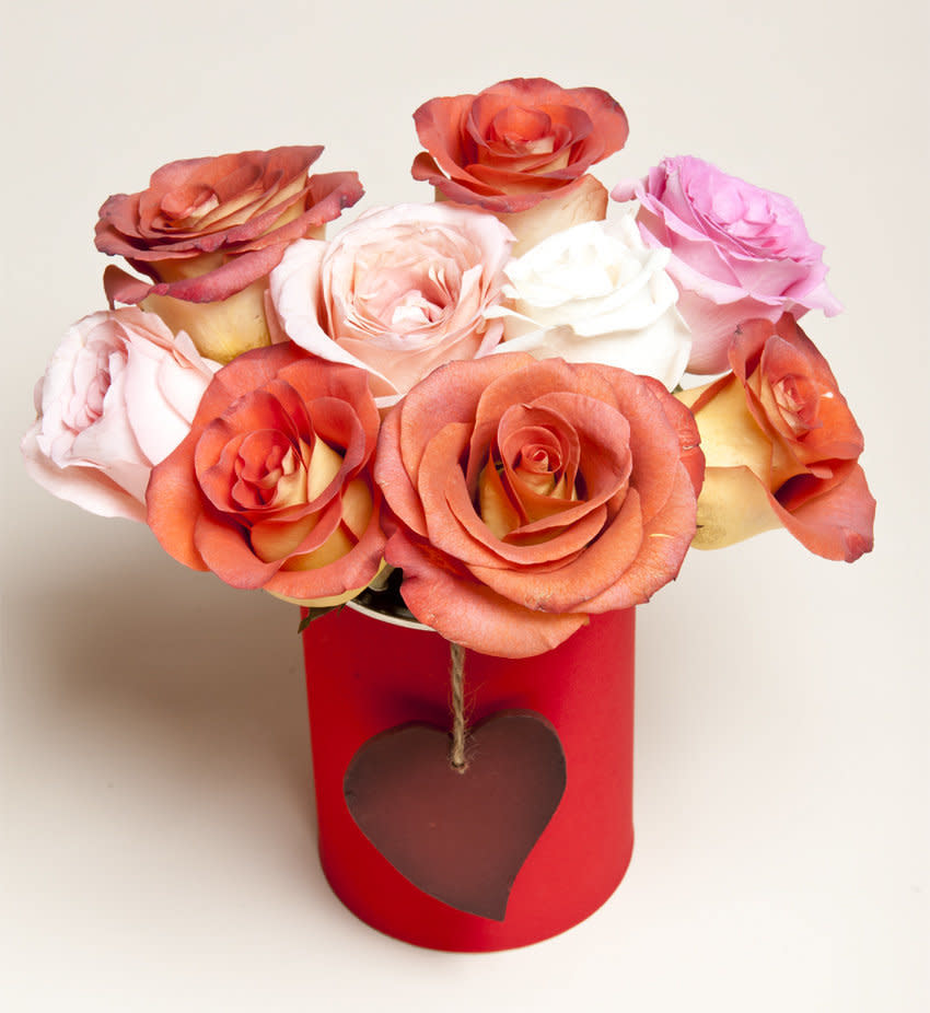 Finally, place your flowers into the canister. We like to group flowers by hue for a more sophisticated arrangement, but you can arrange them however you like.