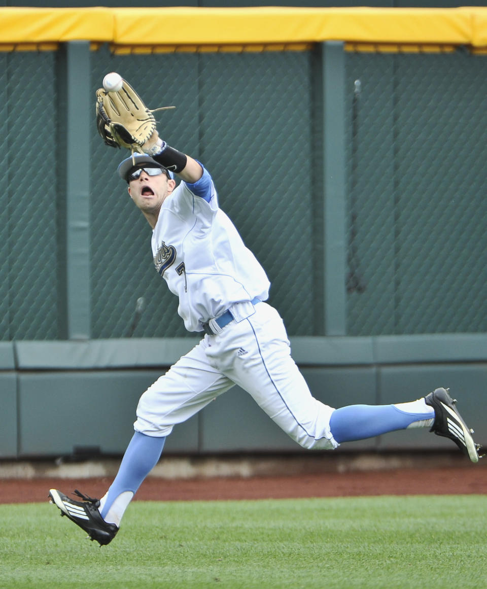 UCLA outfielder Cody Keefer catches a flyball hit by Stony Brook's Pat Cantwell in the third inning of an NCAA College World Series baseball game in Omaha, Neb., Friday, June 15, 2012. (AP Photo/Eric Francis)