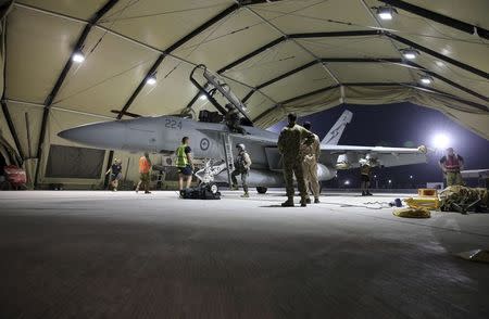 The crew of a Royal Australian Air Force (RAAF) F/A-18F Super Hornet disembark their plane after completing their first combat mission over Iraq in this picture released by the Australian Defence Force October 6, 2014. REUTERS/Australian Defence Force/Handout