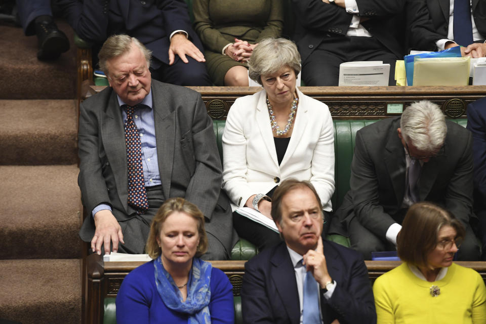 Former Prime Minister Theresa May, top centre, and Father of the House lawmaker Ken Clarke, listen to Britain's Prime Minister Boris Johnson as he gives a statement to lawmakers inside the House of Commons to update details of his new Brexit deal with EU, in London Saturday Oct. 19, 2019. At a rare weekend sitting of Parliament, Johnson implored legislators to ratify the Brexit deal he struck this week with the other 27 EU leaders. (Jessica Taylor/House of Commons via AP)