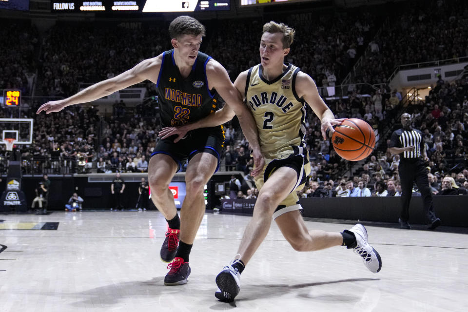 Purdue guard Fletcher Loyer (2) drive son Morehead State guard Riley Minix (22) during the second half of an NCAA college basketball game in West Lafayette, Ind., Friday, Nov. 10, 2023. (AP Photo/Michael Conroy)