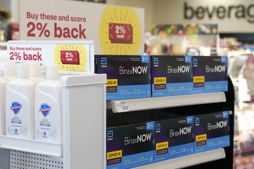 FILE - Boxes of BinaxNow home COVID-19 tests made by Abbott displayed for sale next to liquid hand soap at a CVS store in Lakewood, Wash., Monday, Nov. 15, 2021. People screening themselves at home for COVID-19 may need to use three rapid tests to accurately detect the virus, according to new U.S. recommendations released Thursday, Aug. 11, 2022, that call for a longer testing period. (AP Photo/Ted S. Warren, File)