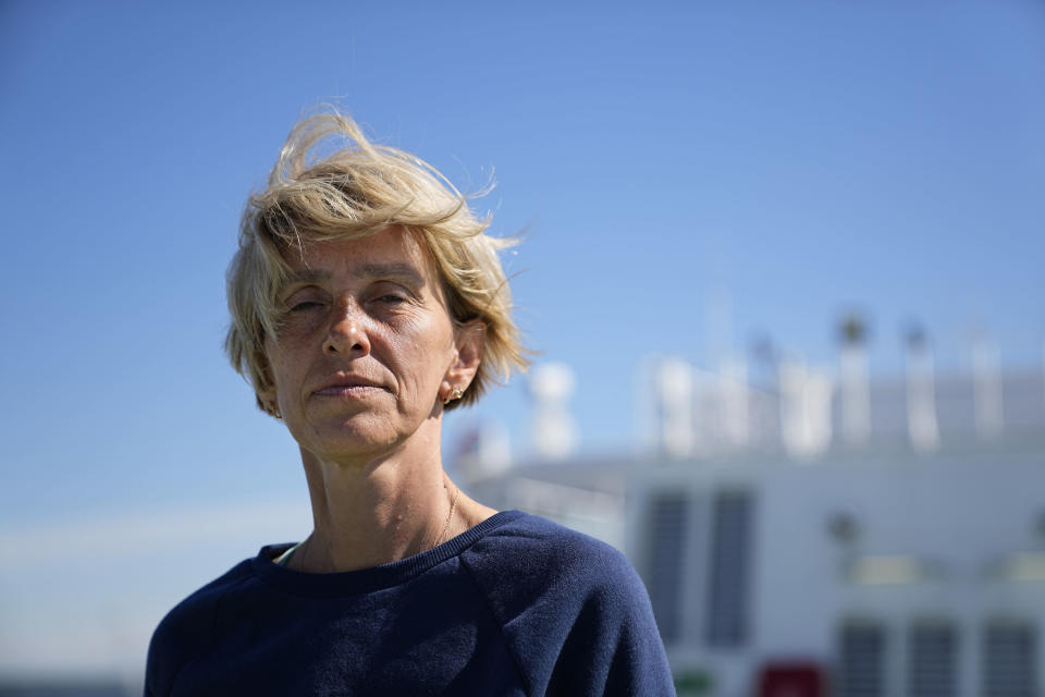 A refugee Olena Zorina stands on a deck of the ferry Isabelle in Tallinn, Estonia, Wednesday, June 15, 2022. Zorina, traveled with her husband and daughter from March 26 to May 1. They received help from Russian volunteers along the way via Russia. Now she is living on the ferry. (AP Photo)