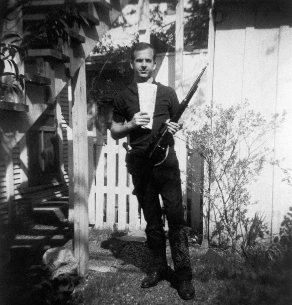 <p>Lee Harvey Oswald holds a Mannlicher-Carcano rifle and newspapers in a backyard. This photograph is one of the controversial backyard photos used in the assassination of John F. Kennedy investigation in 1963. (Photo: Corbis via Getty Images) </p>