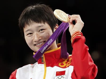 Gold medallist China's Wu Jingyu poses at the women's -49kg taekwondo victory ceremony during the London 2012 Olympic Games at the ExCeL arena August 8, 2012. REUTERS/Kim Kyung-Hoon