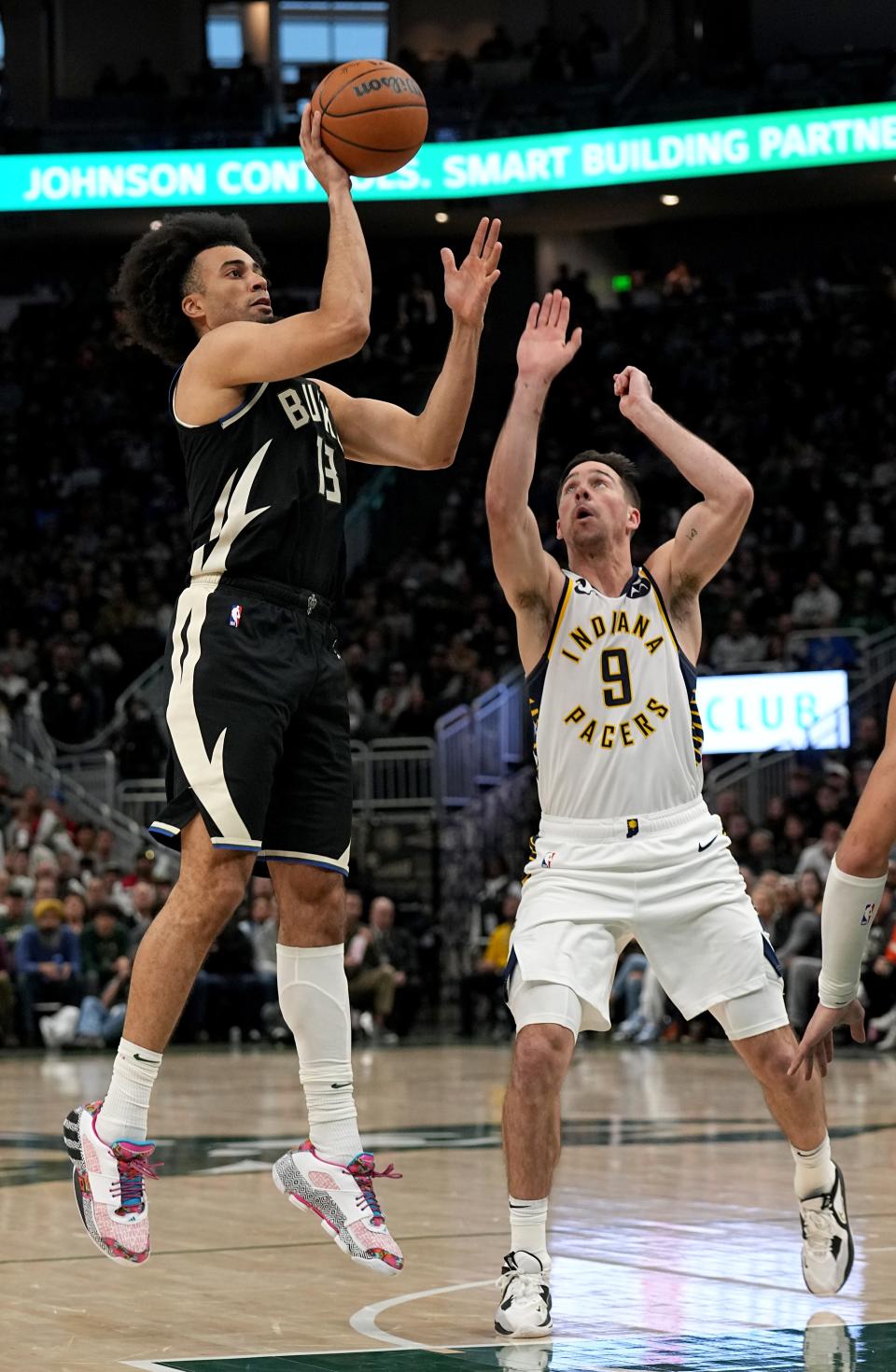 Milwaukee Bucks forward Jordan Nwora (13) shoots over Indiana Pacers guard T.J. McConnell (9) during the second half of their game Monday, January 16, 2023 at Fiserv Forum in Milwaukee, Wis. The Milwaukee Bucks beat the Indiana Pacers 132-119.