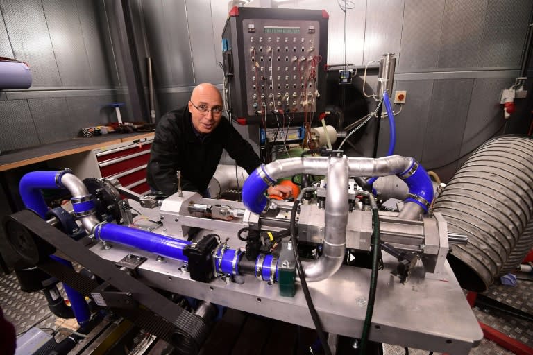 Shaul Yakobi, inventor and co-founder of Aquarius Engines, poses next to a single piston combustion engine invented by the firm to drastically reduce fuel consumption