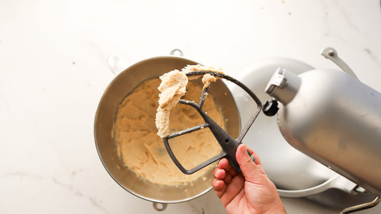 Whipped hazelnut ganache on beater of stand mixer