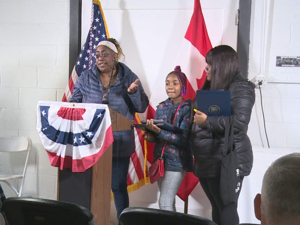 Bernita Flowers and Terri and Tionne George, bystanders who saw Spencer Baker fall from the Ambassador Bridge, received awards on Friday, Feb. 9, 2024, in  recognition of their quick actions that led to Baker's rescue.  (Michael Evans/CBC - image credit)