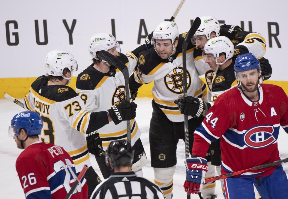 Boston Bruins players celebrate a goal by teammate Patrice Bergeron (37) against the Montreal Canadiens during first-period NHL hockey game action in Montreal, Sunday, April 24, 2022. (Graham Hughes/The Canadian Press via AP)