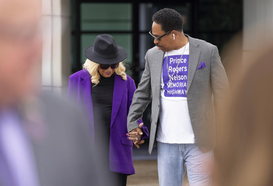 Sharon Nelson, Prince's sister, holds hands with Mark Webster, a major advocate for the bill, before Minnesota Gov. Tim Walz signed a bill renaming a 7-mile stretch of Highway 5 as "Prince Rogers Nelson Memorial Highway", Tuesday, May 9, 2023, at Paisley Park in Chanhassen, Minn. (Alex Kormann/Star Tribune via AP)