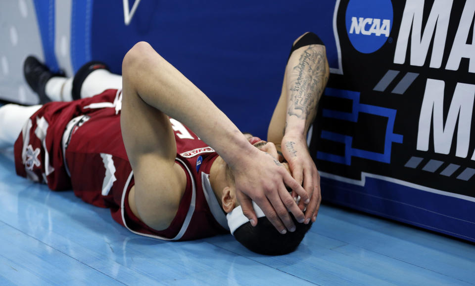 <p>New Mexico State guard Trevelin Queen falls to the court after missing the final shot in the second half during a first round men’s college basketball game against Auburn in the NCAA Tournament, Thursday, March 21, 2019, in Salt Lake City. (Rick Bowmer/AP) </p>