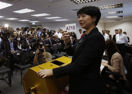 Property sales agents representing buyers look on during a draw, organized by a property developer, from more than 1,500 buyers on getting 80 flats of a private residential estate in Hong Kong October 31, 2013. REUTERS/Bobby Yip