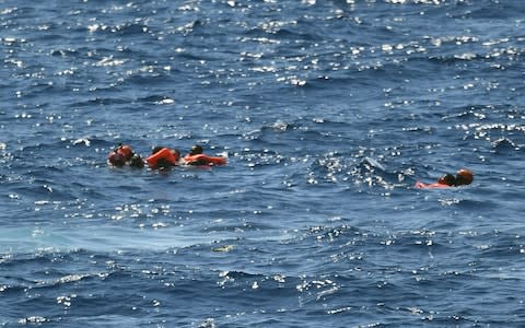 Migrants who jumped off the Spanish humanitarian rescue ship Open Arms are rescued after a desperate bid to reach the shore of the island of Lampedusa, southern Italy - Credit: Salvatore Cavalli&nbsp;/AP