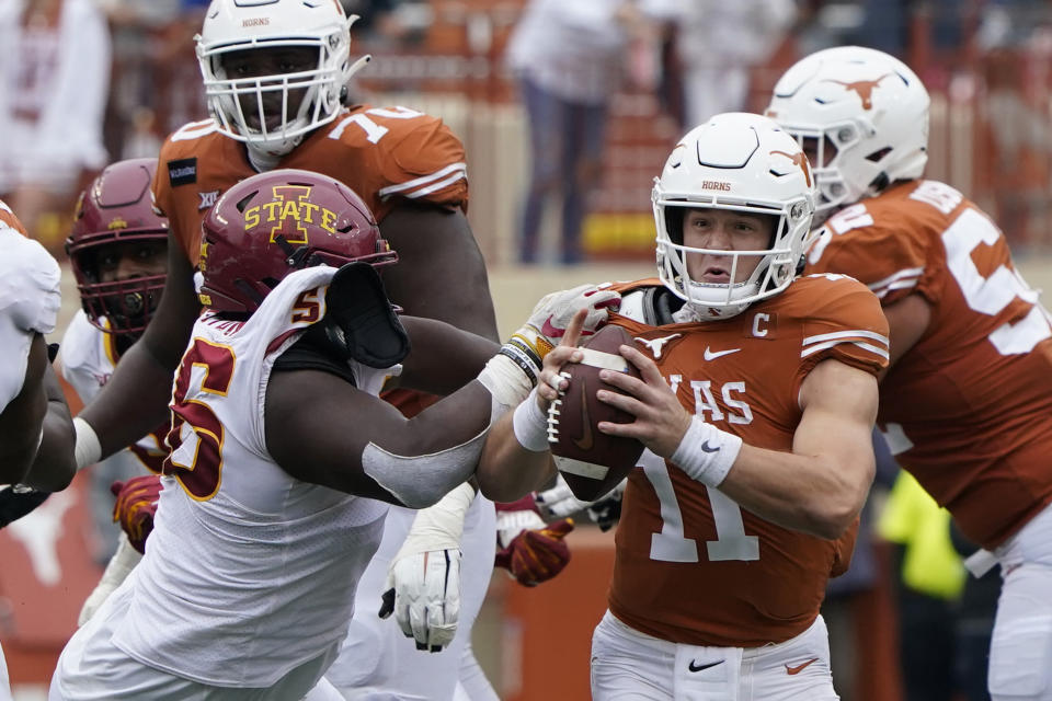 Texas quarterback Sam Ehlinger (11) is pressured by Iowa State defensive lineman Latrell Bankston (56) during the second half of an NCAA college football game, Friday, Nov. 27, 2020, in Austin, Texas. (AP Photo/Eric Gay)