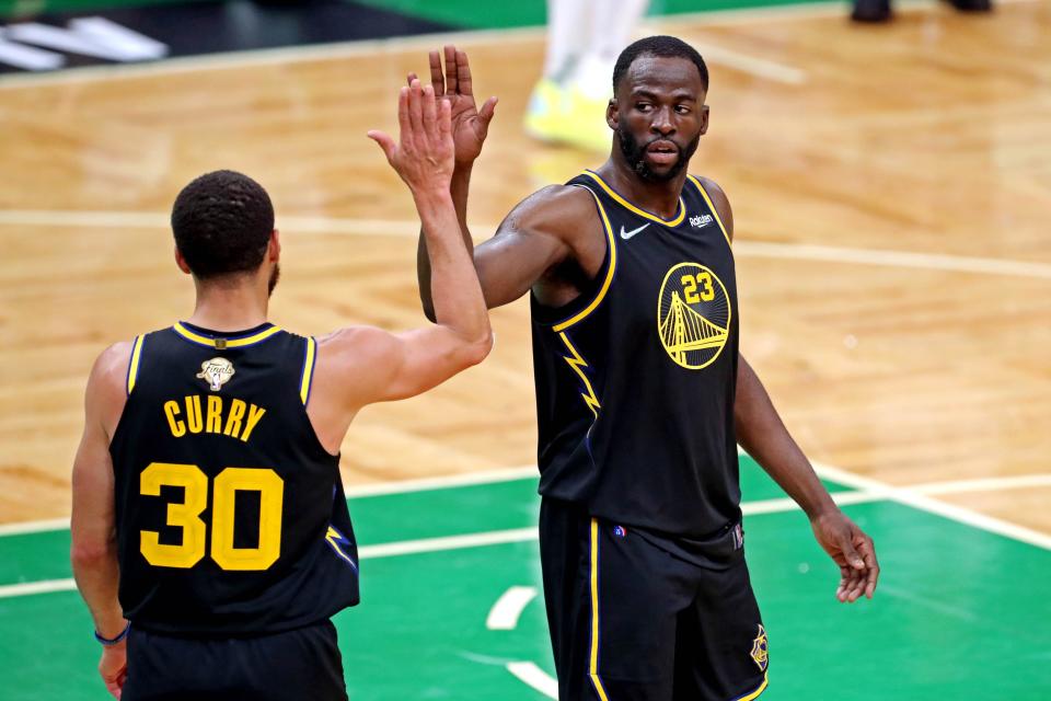 Golden State Warriors guard Stephen Curry (30) celebrates with Golden State Warriors forward Draymond Green (23) during the fourth quarter during game four of the 2022 NBA Finals at TD Garden.