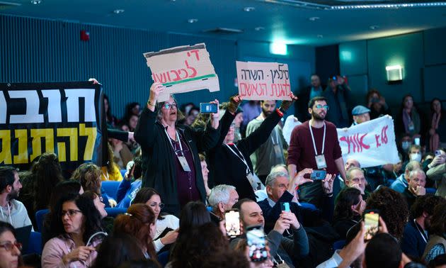 Demonstrators gather at the climate summit at Ben-Gurion University, shouting “shame on you” in Hebrew at Silman.