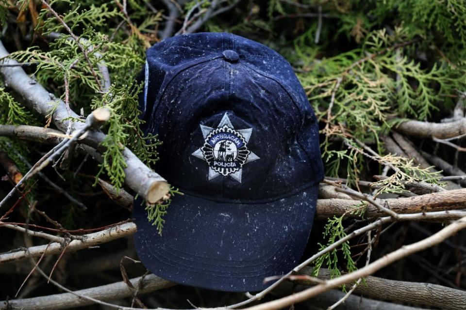 This Oct. 16, 2019 photo, shows a cap of one of the state police officers who were shot or burned to death in their vehicles, in El Aguaje, Mexico. Thirteen state police officers were shot or burned to death in their vehicles.
