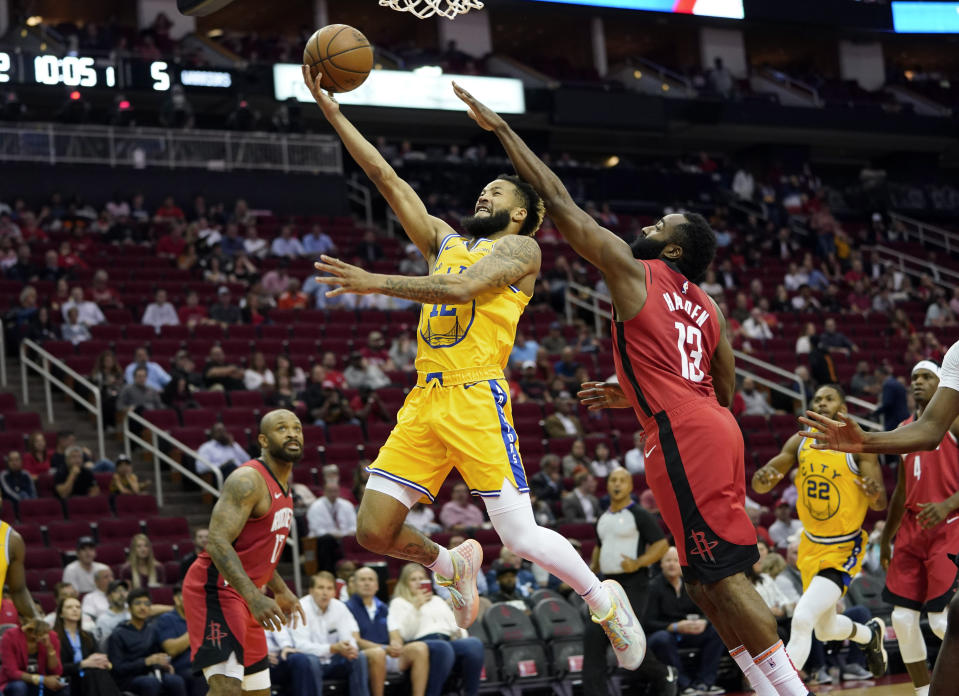 Golden State Warriors' Ky Bowman (12) goes up for a shot as Houston Rockets' James Harden (13) defends during the first half of an NBA basketball game Wednesday, Nov. 6, 2019, in Houston. (AP Photo/David J. Phillip)