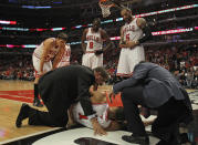 CHICAGO, IL - APRIL 28: Derrick Rose #1 of the Chicago Bulls is examined after suffering an injury against the Philadelphia 76ers as teammates (L-R) Kyle Korver #26, Loul Deng #9 and Carlos Boozer #5 watch in Game One of the Eastern Conference Quarterfinals during the 2012 NBA Playoffs at the United Center on April 28, 2012 in Chicago, Illinois. The Bulls defeated the 76ers 103-91. NOTE TO USER: User expressly acknowledges and agrees that, by downloading and or using this photograph, User is consenting to the terms and conditions of the Getty Images License Agreement. (Photo by Jonathan Daniel/Getty Images)