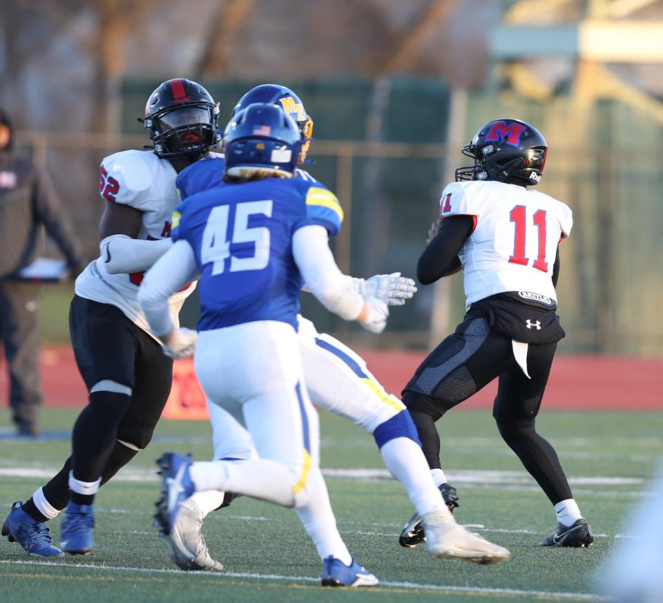 Monroe quarterback Khaya Moses winds up to throw a 58-yard touchdown pass during the first half of their semifinal game at Cicero-North Syracuse High School. This pass gave him the new Section V football single-season touchdown passes record.