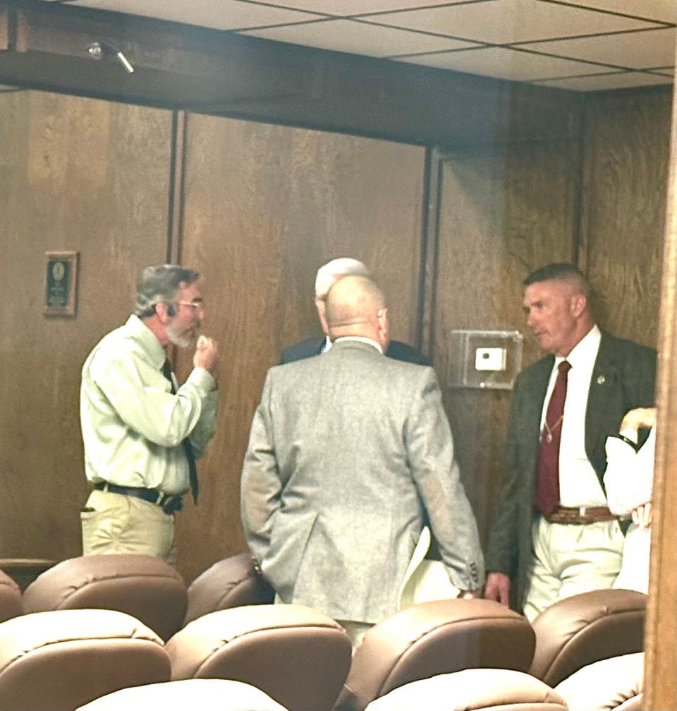 Suspended Clay County Sheriff Jeffrey Lyde, far right, lingers in 97th District Court after his sentencing Tuesday at the Montague County Courthouse for official oppression and tampering with governmental documents.