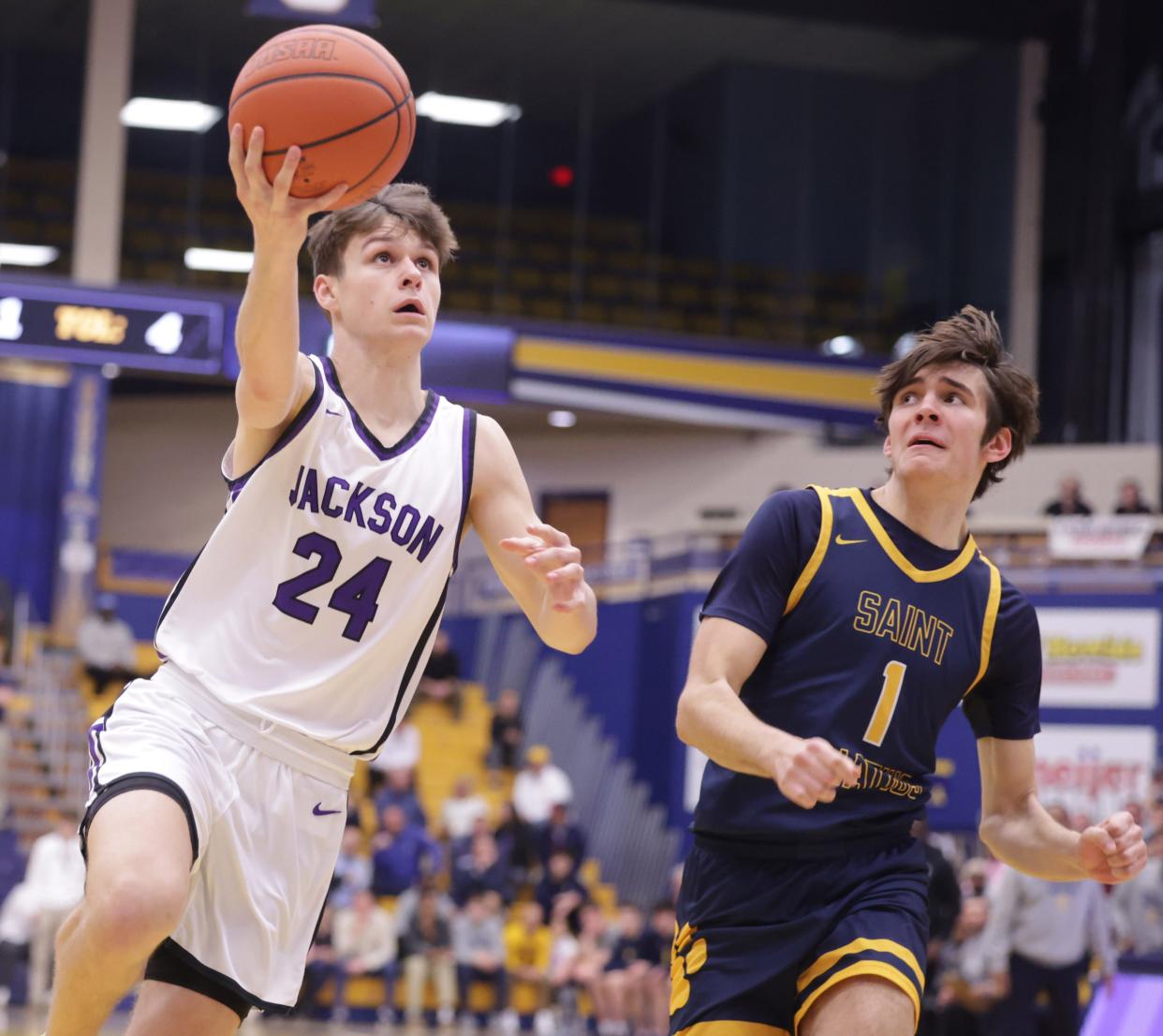 Jackson's Kyle Monterrubio drives against Cleveland St. Ignatius' Mike Lamirand in an OHSAA boys basketball regional semifinal at Kent State, Wednesday, March 13, 2024.