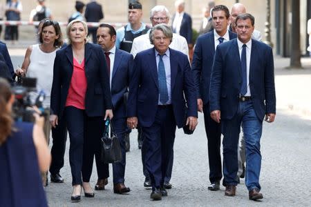 FILE PHOTO: Newly-elected members of parliament Louis Aliot, Ludovic Pajot, Gilbert Collard, Bruno Bilde, Sebastien Chenu, Emmanuelle Menard, Jose Evrard and Marine Le Pen of France's far-right National Front (FN) political party arrive at the National Assembly in Paris, France, June 21, 2017. REUTERS/Charles Platiau/File Photo