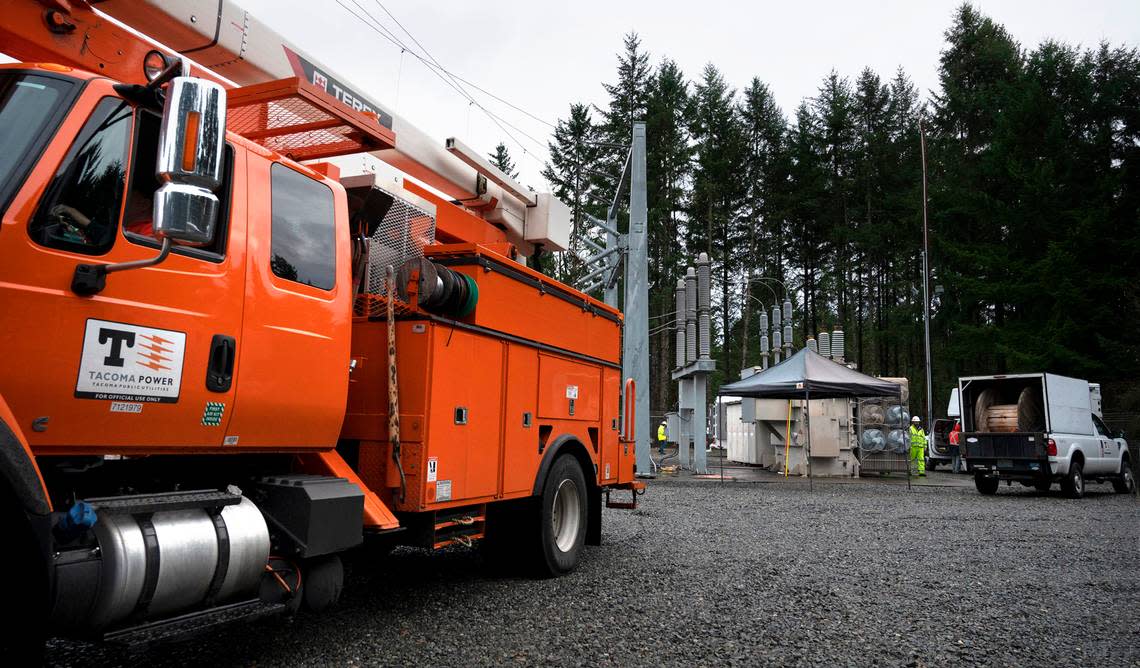 Tacoma Public Utilities workers switch the 224th Street East substation to a mobile transformer to restore power in Graham, Wash., on Monday, Dec. 26, 2022.