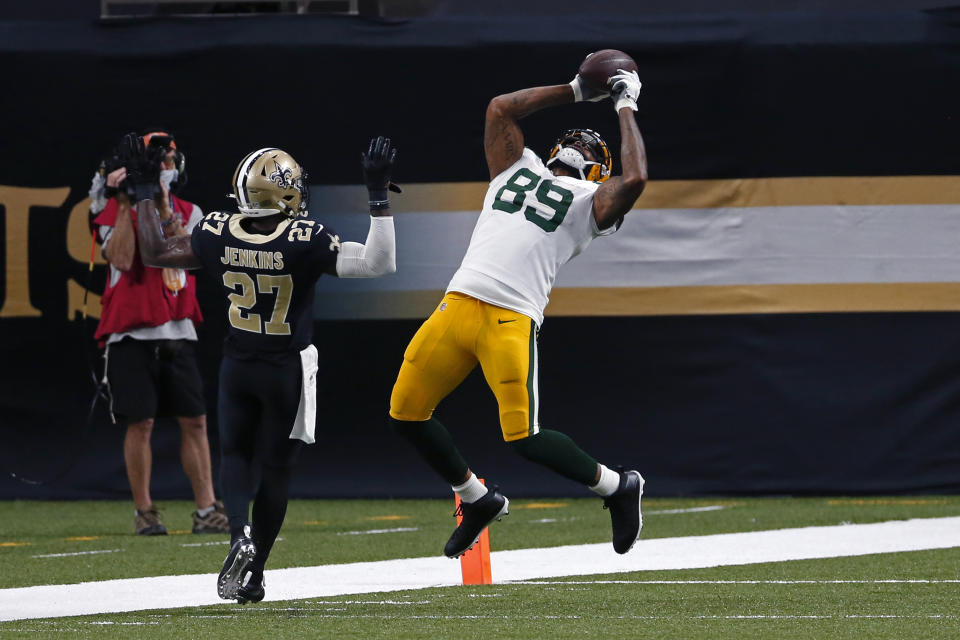 Green Bay Packers tight end Marcedes Lewis (89) pulls in a touchdown reception in front of New Orleans Saints strong safety Malcolm Jenkins (27) in the second half of an NFL football game in New Orleans, Sunday, Sept. 27, 2020. (AP Photo/Brett Duke)