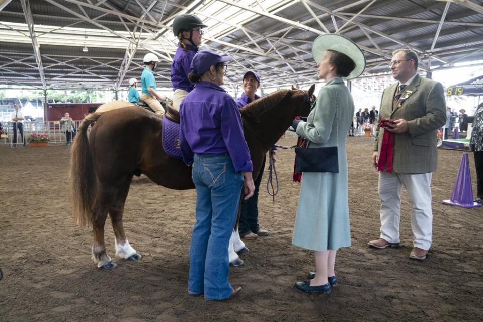 The Princess Royal awards rosettes after watching a display organised by Riding for the Disabled Association (Kirsty O’Connor/PA) (PA Wire)