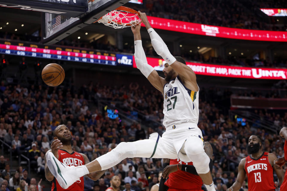 FILE - In this Feb. 22, 2020, file photo, Utah Jazz's Rudy Gobert (27) dunks during the second half of an NBA basketball game against the Houston Rockets in Salt Lake City. Gobert is standing tall, even after having coronavirus and dealing with an enormous amount of scorn after being diagnosed. He was the first NBA player to test positive for the virus and that prompted many to blame him for the league's shutdown in response to the pandemic. (AP Photo/Kim Raff, File)