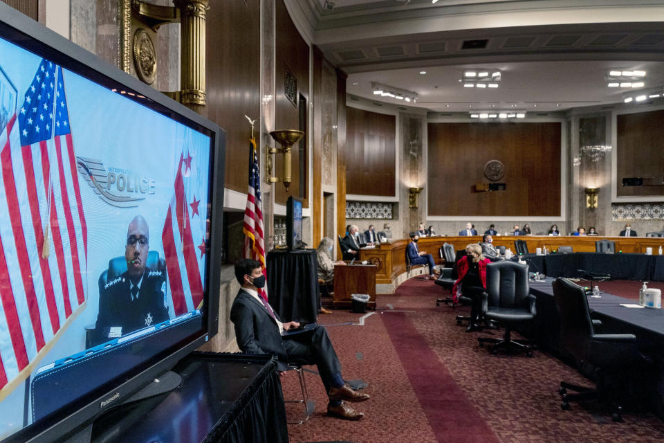 Washington Metropolitan Police Department Acting Chief of Police Robert Contee III, left, testifies via teleconference before a Senate Homeland Security and Governmental Affairs & Senate Rules and Administration joint hearing on Capitol Hill, Washington, Tuesday, Feb. 23, 2021, to examine the January 6th attack on the Capitol. (AP Photo/Andrew Harnik, Pool)