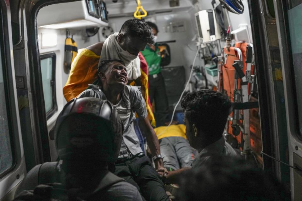 An injured protester reacts in pain as he is shifted to hospital in an ambulance during clashes with police near parliament in Colombo, Sri Lanka, July 13, 2022. The image was part of a series of images by Associated Press photographers that was a finalist for the 2023 Pulitzer Prize for Breaking News Photography. (AP Photo/Rafiq Maqbool)