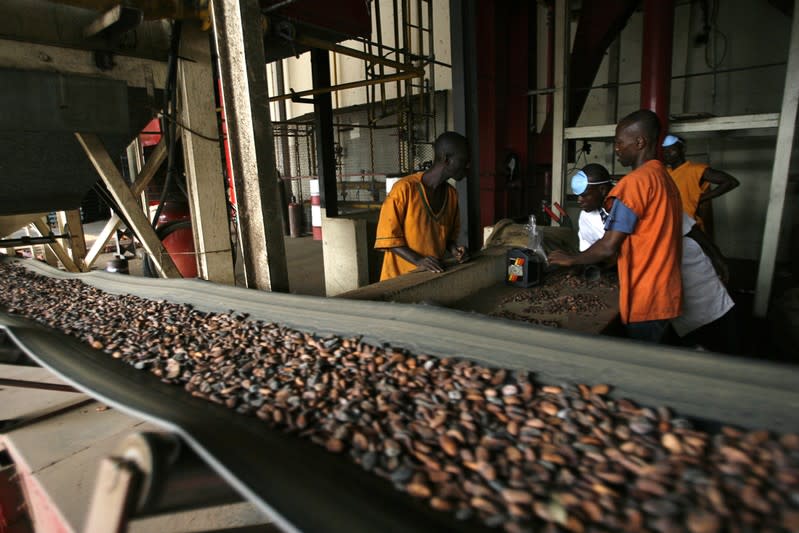 Workers handle cocoa beans at a Barry Callebaut cocoa factory in San Pedro