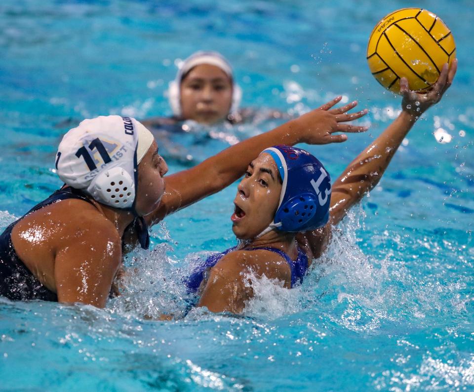Indio's Sienna Rodriguez (13) looks to pass under pressure from Anaheim's Rosabelle Estelles (11) during their CIF-SS Division 6 semifinal game in Indio, Calif., Wednesday, Feb. 14, 2024.