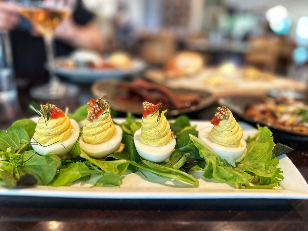 At Colab Kitchen restaurant in Stuart, the deviled eggs are crowned with a bit of tomato jam and pickled mustard seed.