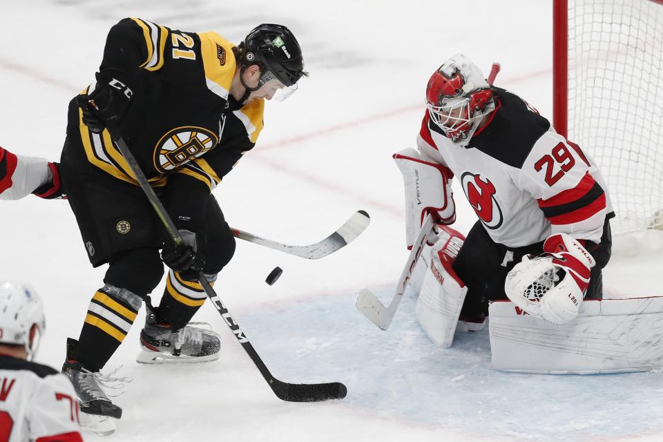 Boston Bruins' Nick Ritchie (21) tries to get a shot on New Jersey Devils' Mackenzie Blackwood (29) during the third period of an NHL hockey game, Sunday, March 28, 2021, in Boston. (AP Photo/Michael Dwyer)