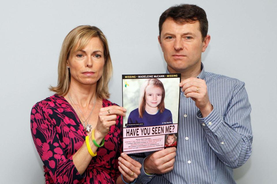 Kate and Gerry McCann hold a missing poster for Madeleine (REUTERS)