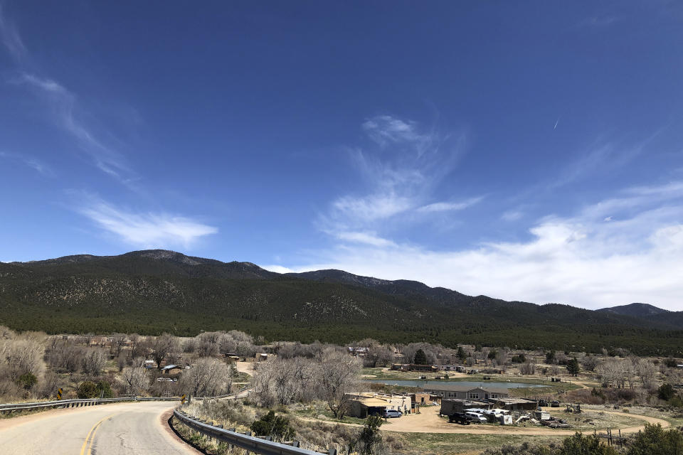 This April 13, 2020 photo shows the Native American community of Picuris Pueblo, N.M. Small Native American pueblo tribes across New Mexico are embracing extraordinary social distancing measures that include guarded roadblocks and universal testing for the coronavirus in efforts to insulate themselves from a contagion with frightening echoes of the past. (AP Photo/Morgan Lee)