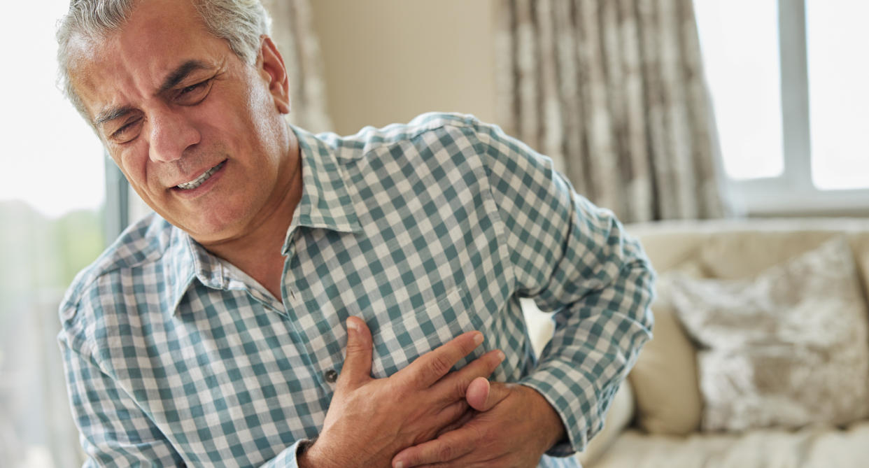Man clutching chest as heart disease is one of the leading causes of death for men in the UK. (Getty Images)