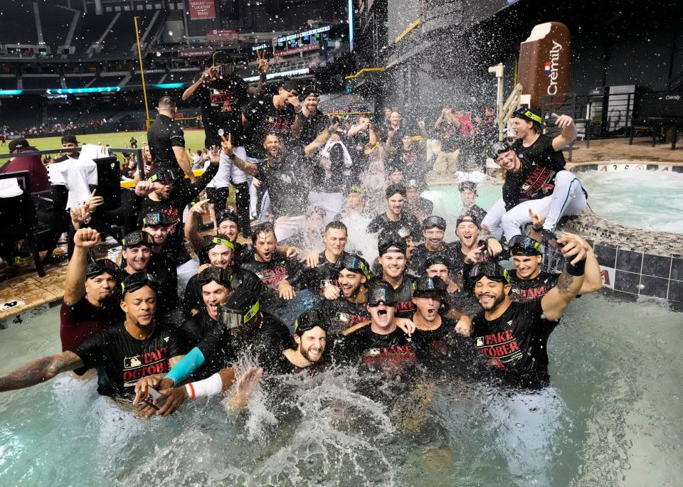 The Arizona Diamondbacks celebrate after clinching a playoff berth.