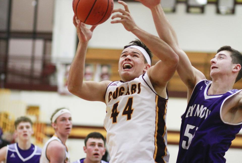Bloomington North’s Aaron Steinfeldt (44) goes up for a shot against Seymour’s Elijah Corwin (55) during a game on Jan. 5 at the Cougar Den.