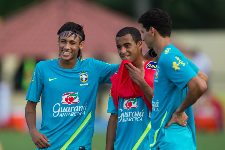 Brazil's Neymar, left, jokes with teammates Lucas, center and Ganso during a training session in preparation for the London 2012 Olympics in Rio de Janeiro, Brazil, Wednesday July 11, 2012. (AP Photo/Felipe Dana)