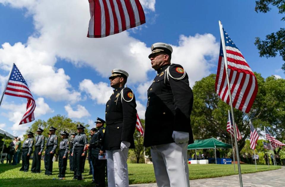 Arnold Piedrahita, teniente de los Bomberos de Miami-Dade, y el bombero Robert Ortega participan en la ceremonia de tributo a las víctimas de los ataques terroristas del 11 de septiembre de 2001, en Tropical Park, Miami, el domingo 11 de septiembre de 2022.