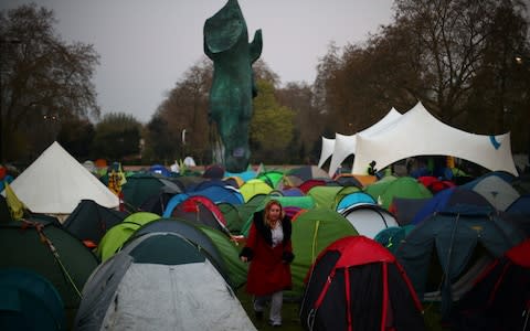 Activists set up tents at Marble Arch as part of ongoing climate change protests - Credit: Hannah McKay/Reuters